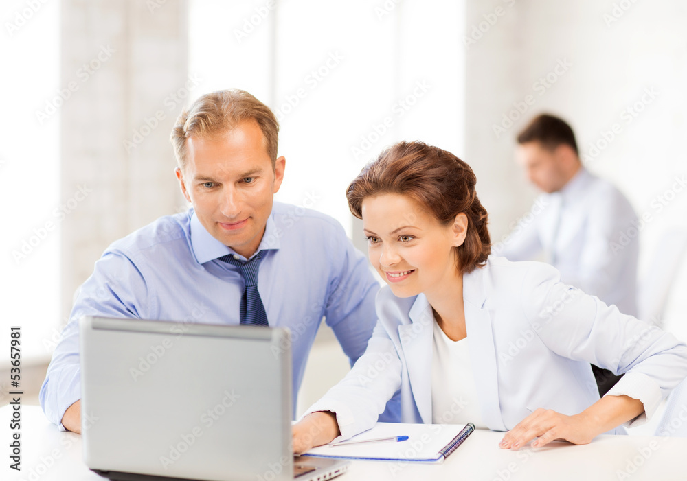 man and woman working with laptop in office man and woman working with laptop in office
