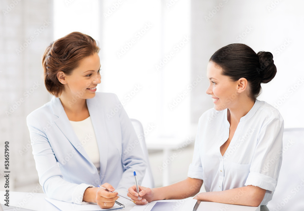 two businesswomen having discussion in office two businesswomen having discussion in office