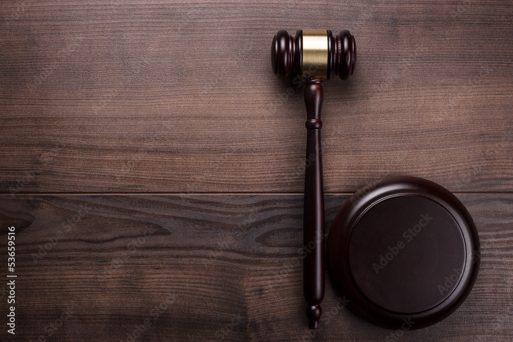 judge gavel on brown wooden background judge gavel on brown wooden background