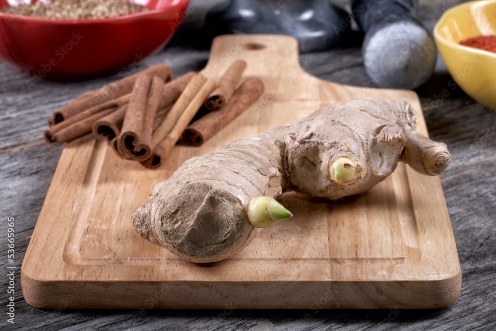 Fototapeta premium Still-life with ginger and cinnamon on an old kitchen table