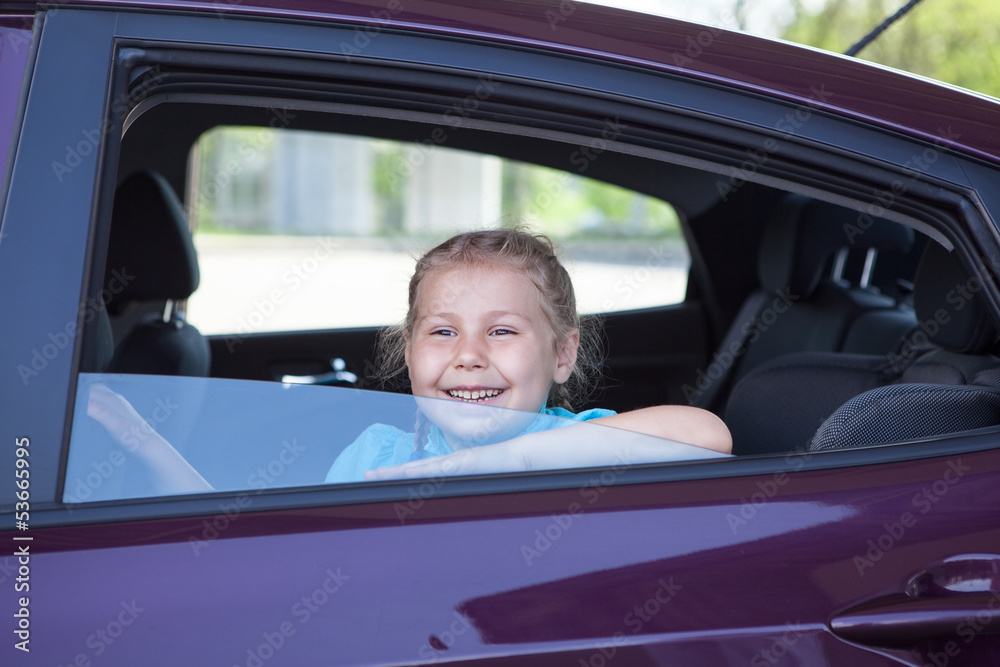 Happy smiling Caucasian girl sitting inside of car Happy smiling Caucasian girl sitting inside of car
