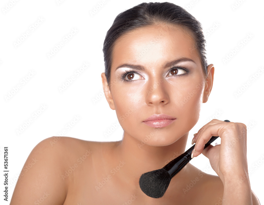 Portrait of attractive young adult woman applying blusher Portrait of attractive young adult woman applying blusher