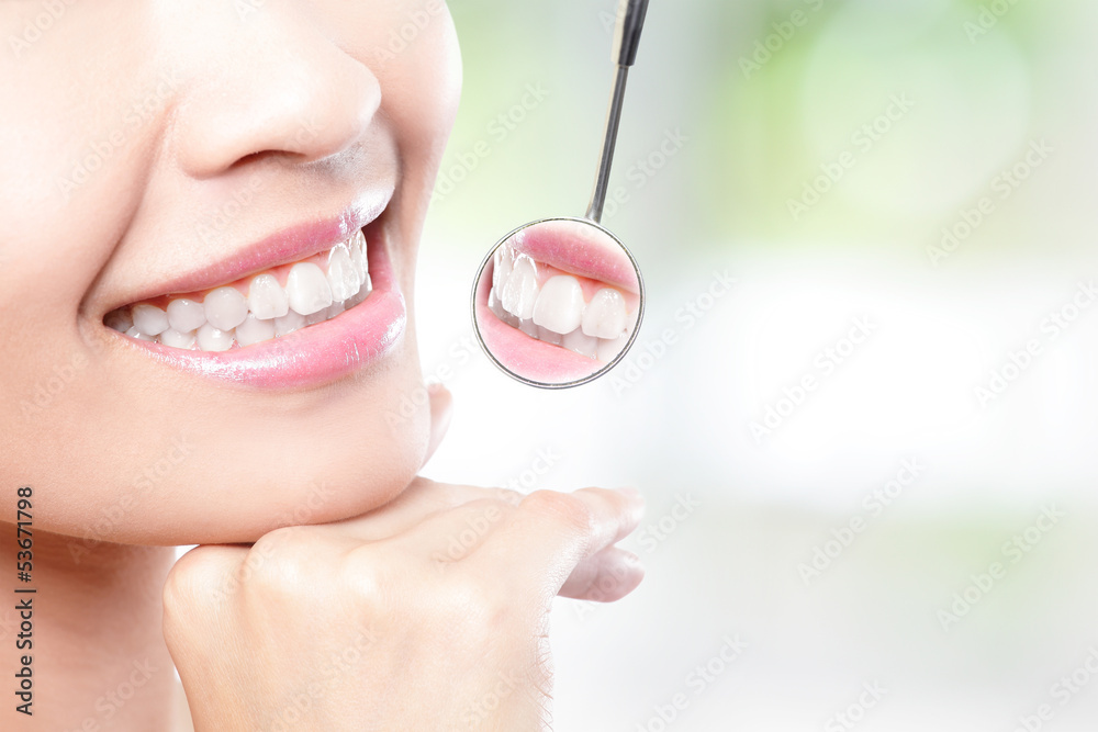 Naklejka premium Healthy woman teeth and dentist mouth mirror