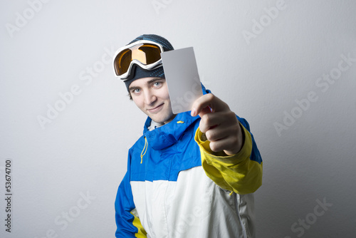 Young man holding blank lift pass