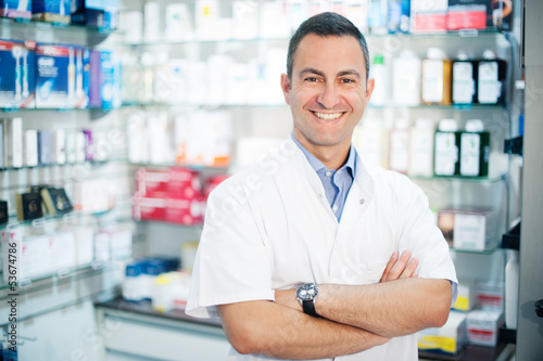 Smiling caucasian pharmacist posing in a pharmacy