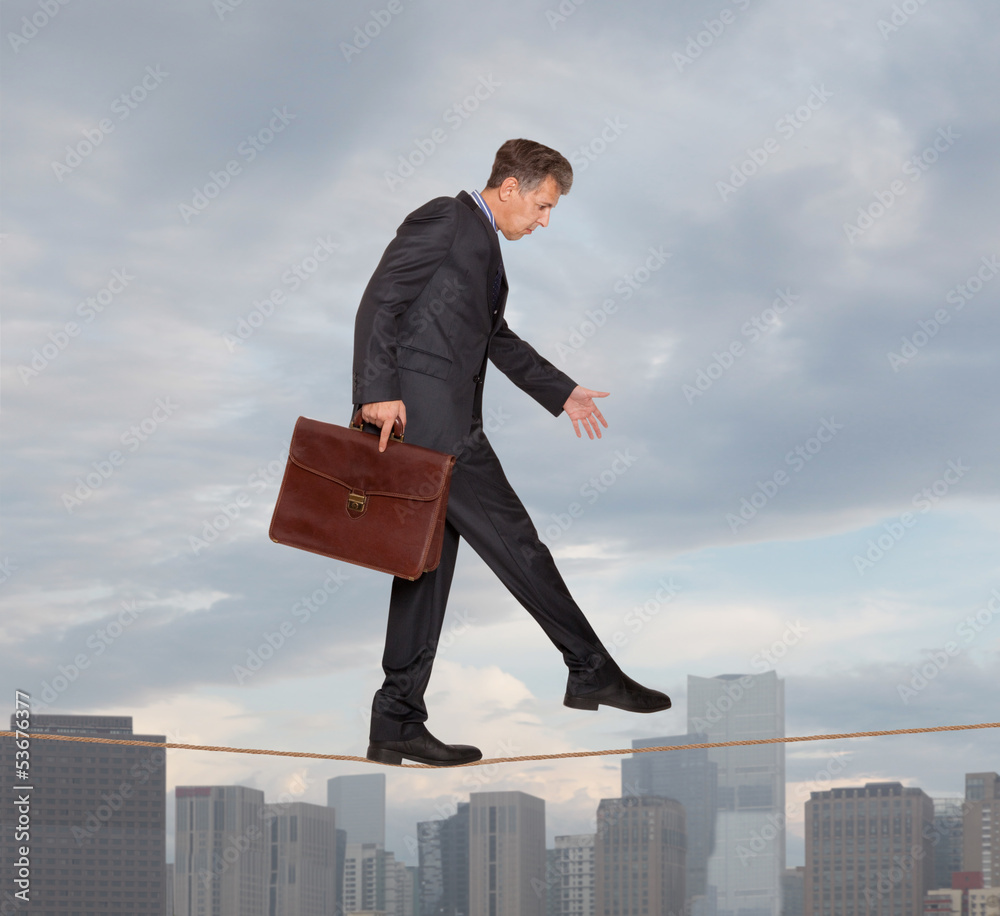 Businessman rope-walker
