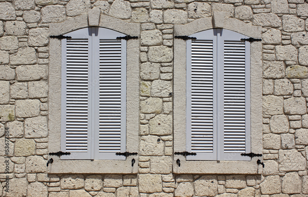 Wall of limestone masonry with windows