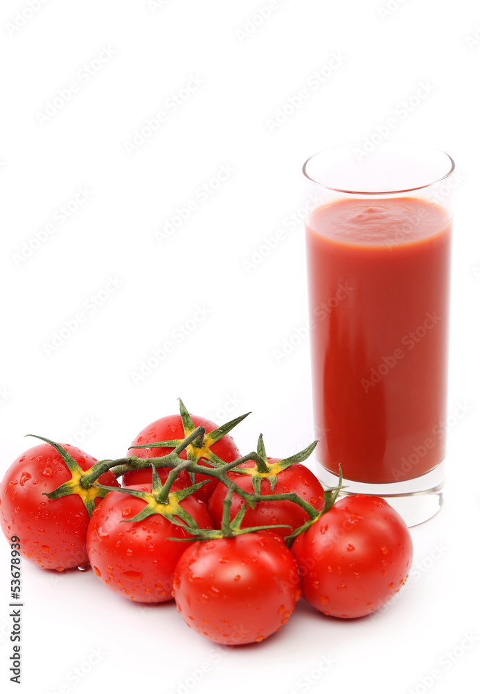 Tomato juice in glass with a cluster of tomatoes Tomato juice in glass with a cluster of tomatoes