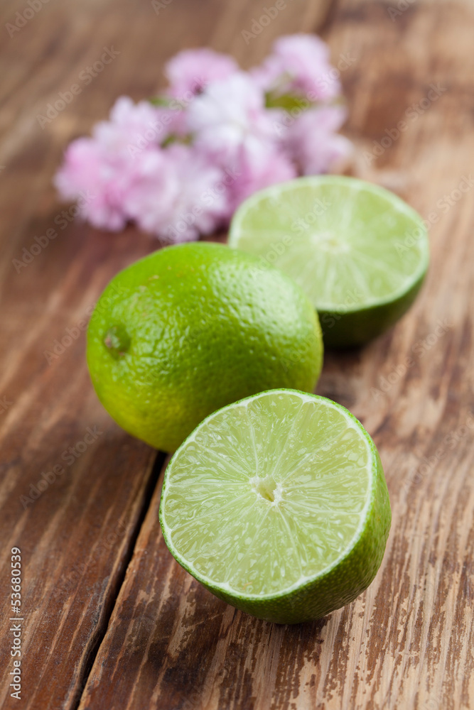 Limes on wooden background