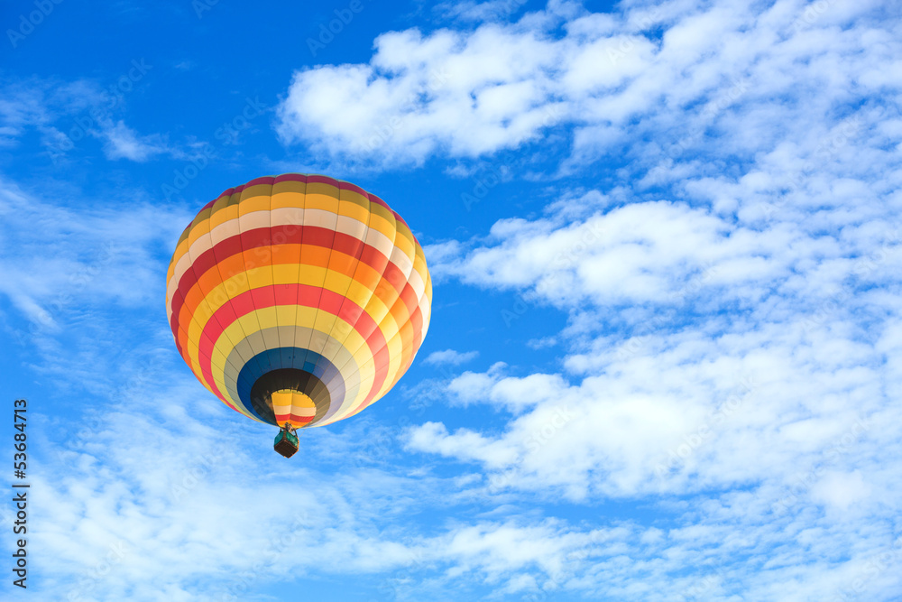 Obraz premium Colorful hot air balloon over blue sky