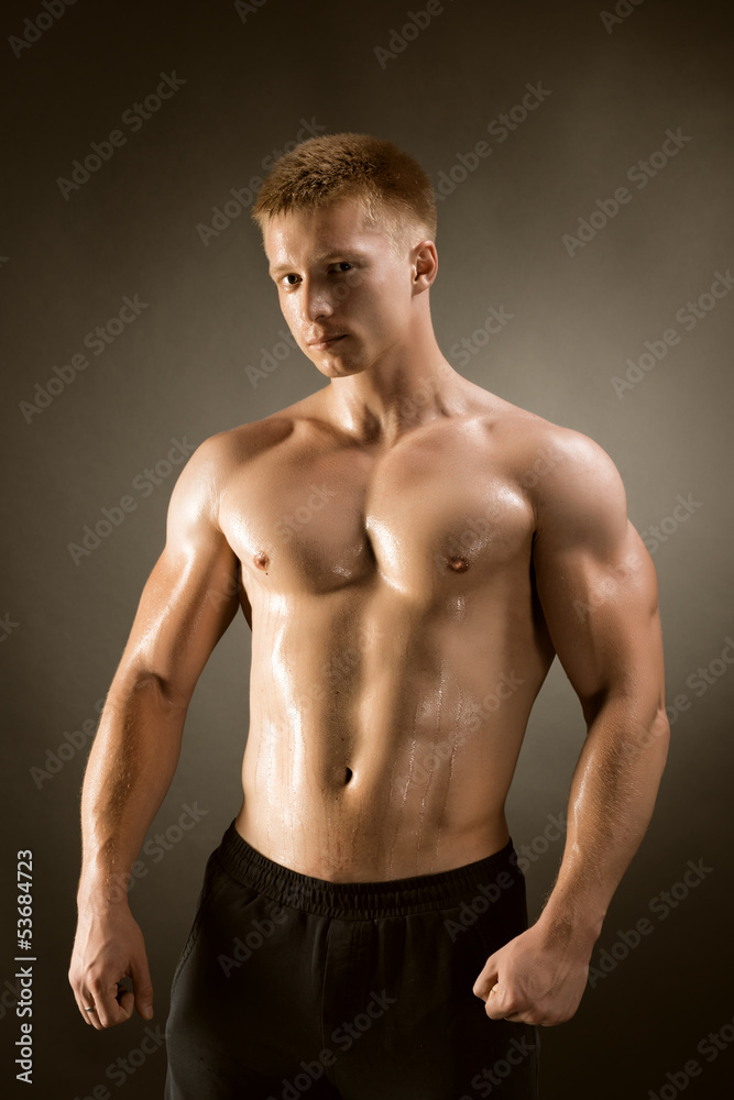 Healthy muscular young man  posing in studio