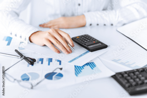 woman hand with calculator and papers photo
