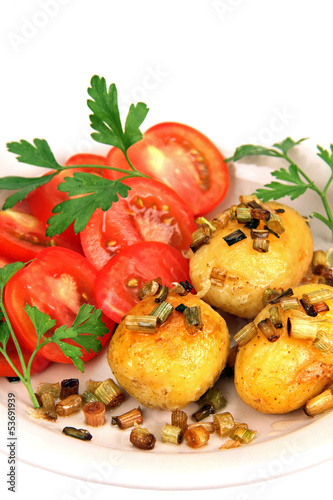 roasted potatoes with tomatoes.