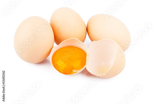 Chicken raw eggs, whole and broken on white, food photo