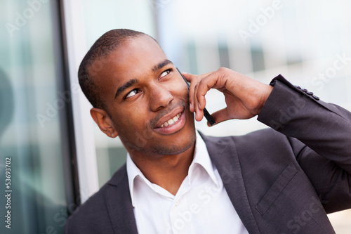 Photos Successful african businessman phoning while smiling