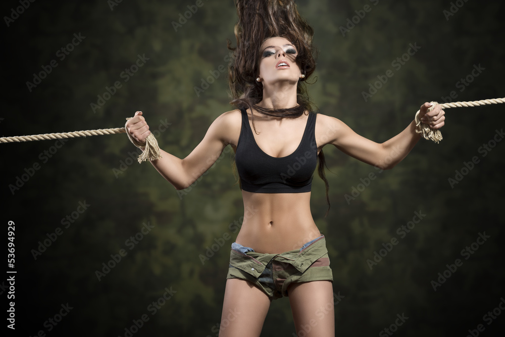 sexy brunette girl tied by rope foto de Stock | Adobe Stock