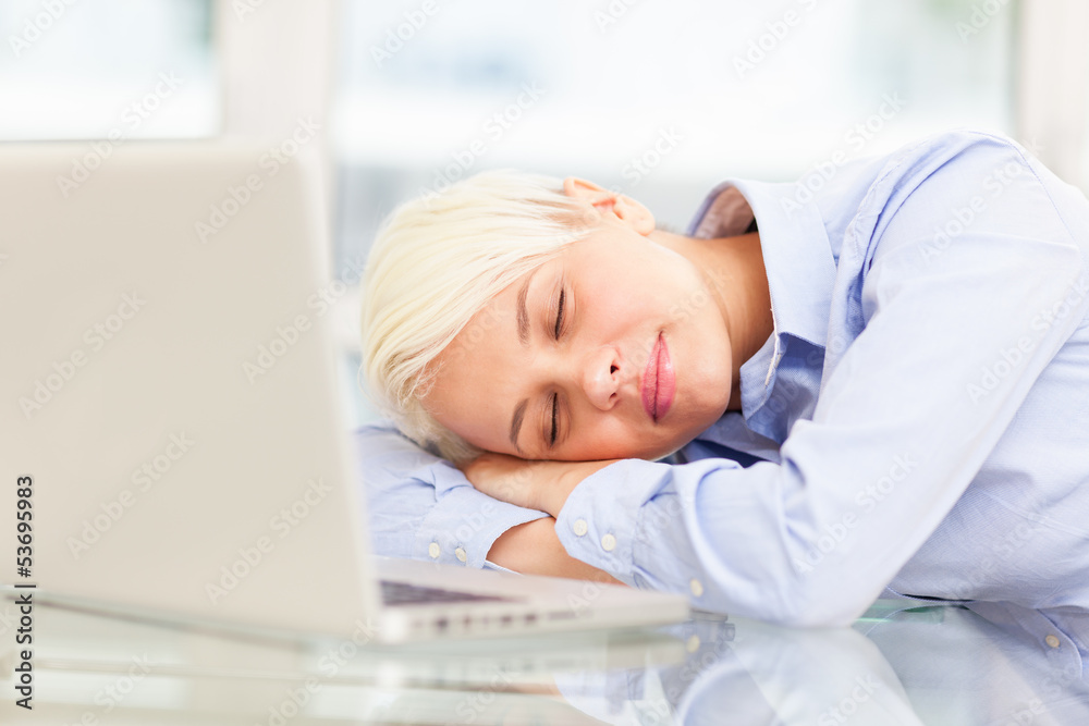 Exhausted businesswoman sleeps on notebook Exhausted businesswoman sleeps on notebook