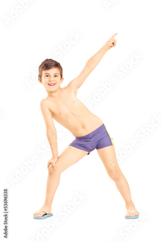 Full length portrait of a boy in swimming shorts gesturing with