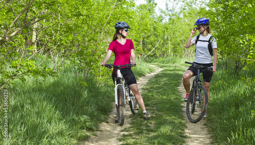 girls  biking in the forest