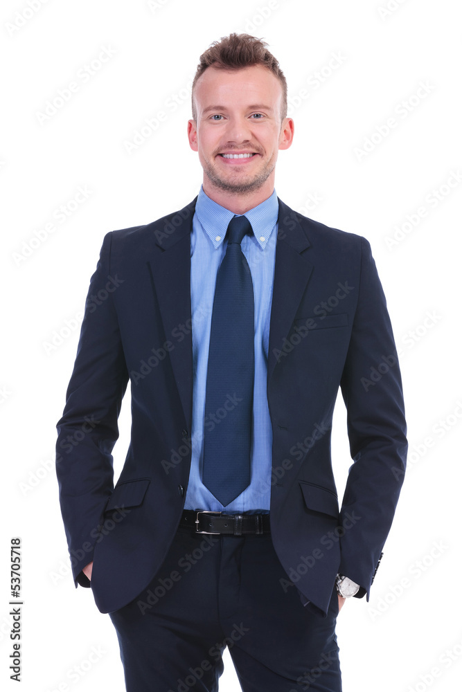 business man smiles with hands in pockets business man smiles with hands in pockets