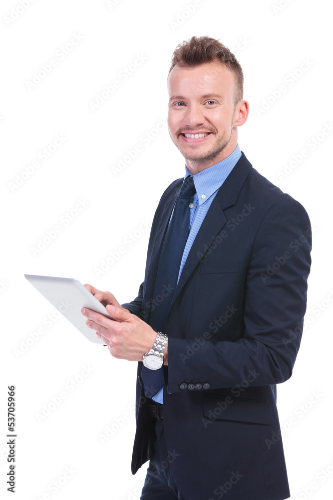 business man works on pad and looks at you business man works on pad and looks at you