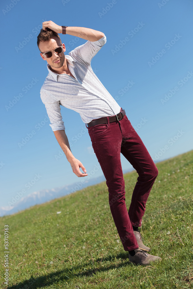casual man adjusts his hair outdoor casual man adjusts his hair outdoor