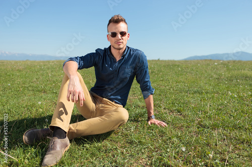 casual man laying in the grass