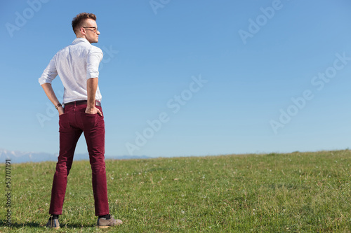 casual man outdoors with his back at you