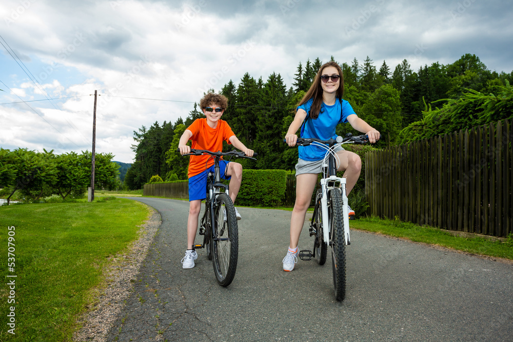 Healthy lifestyle - teenage girl and boy biking Healthy lifestyle - teenage girl and boy biking
