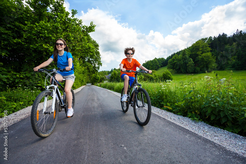 Healthy lifestyle - teenage girl and boy biking