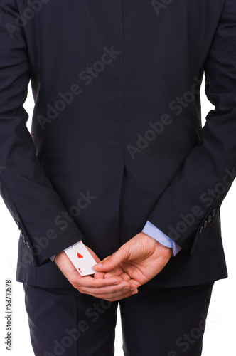 Businessman with ace card hidden under sleeve.