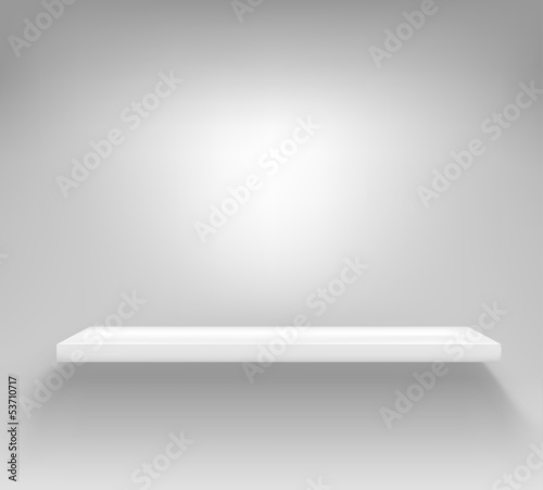 Empty white shelf hanging on a wall