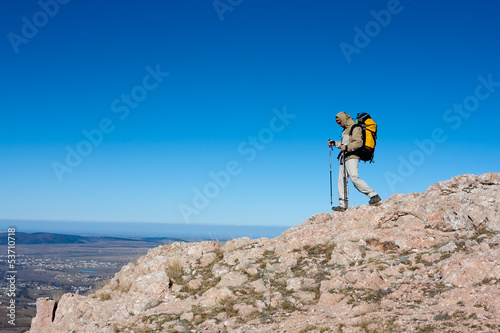 Hiker is standing on top of mountain in Crimea mountains against