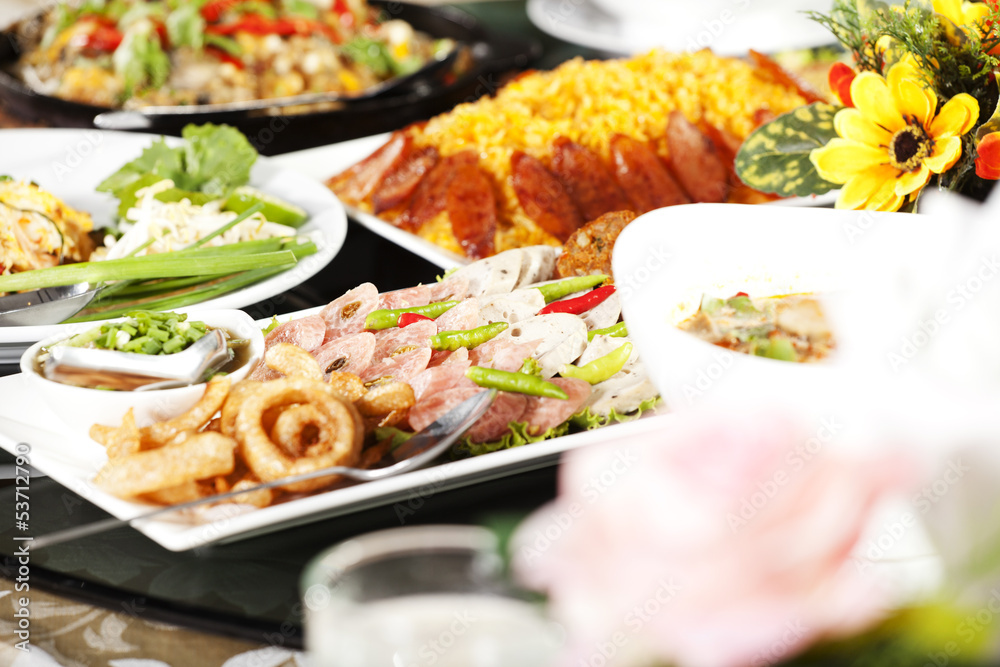 meal time, full round table with colorful food in restaurant