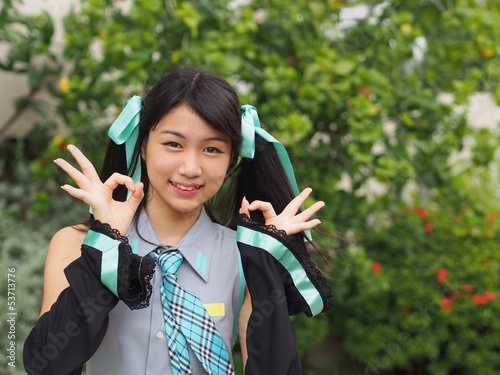 Pretty cosplay girl showing OK sign gesture