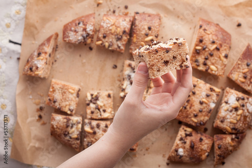 Hand holding a piece of traditional Catalan chocolate brioche photo