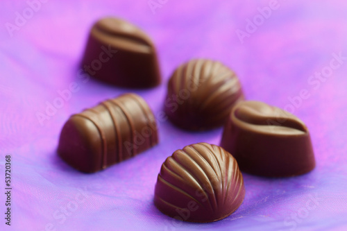 Milky chocolates on purple background