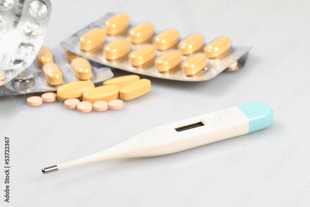 White pills and thermometer White pills and thermometer