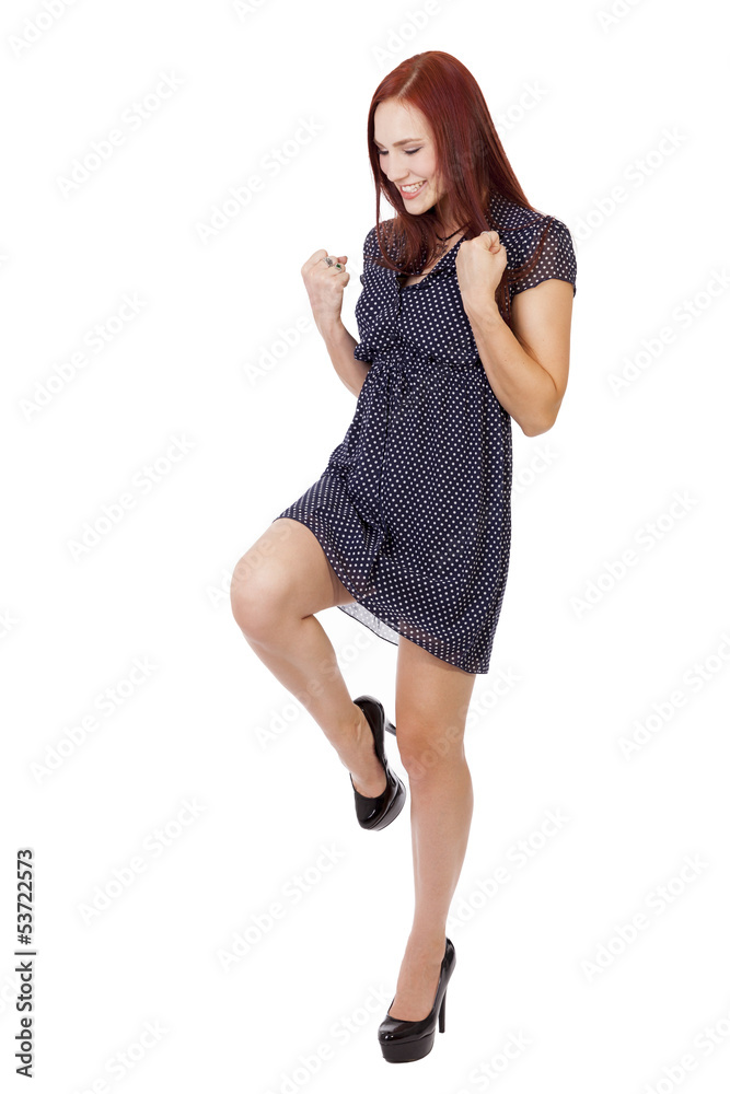 Fototapeta premium Pretty Woman with red hair does a victory pose.