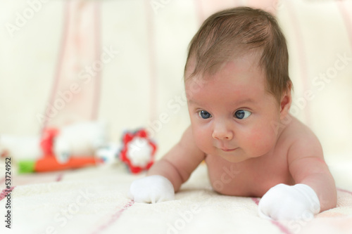 Infant baby (5 weeks old) lying on tummy photo