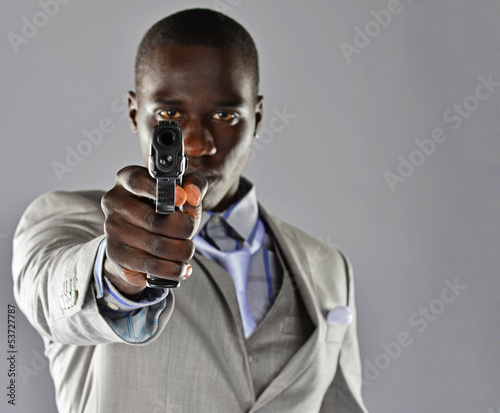 Man in suit with gun