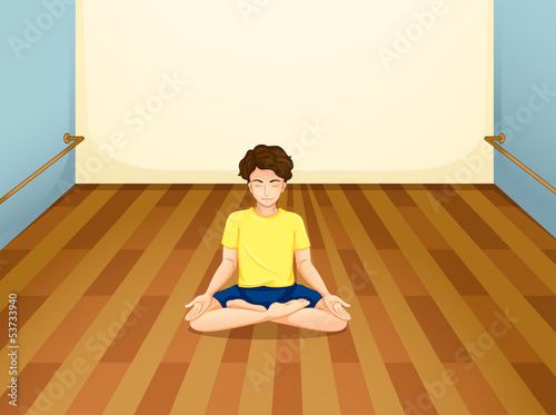 A man with a yellow shirt performing yoga inside a room