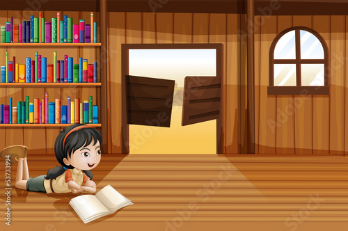 A girl reading a book in the library with a swingdoor