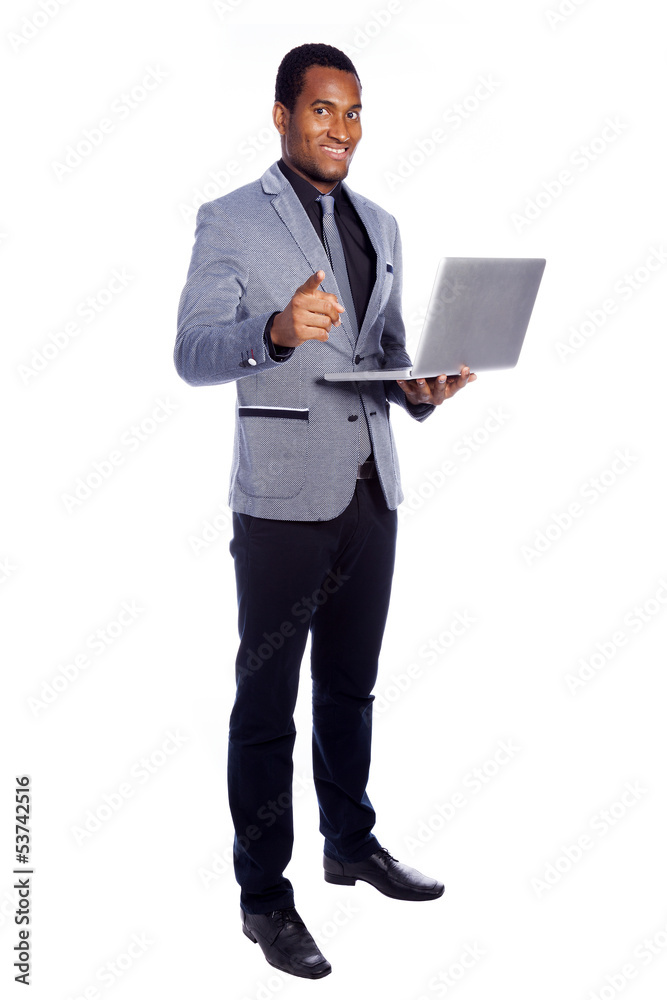 Smiling business man holding a laptop - isolated over a white ba