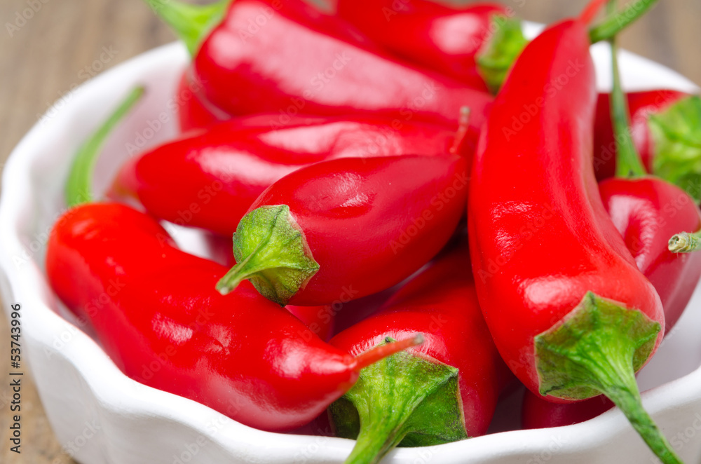 close-up of red hot chili peppers in white bowl close-up of red hot chili peppers in white bowl
