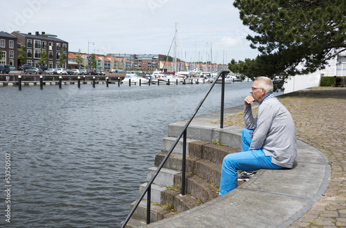 man sitting and thinking near the water © Chris Willemsen 