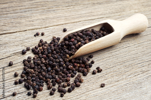 Black pepper in wooden spoon