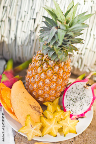 Exotic tropical fruit on the sandy shore photo