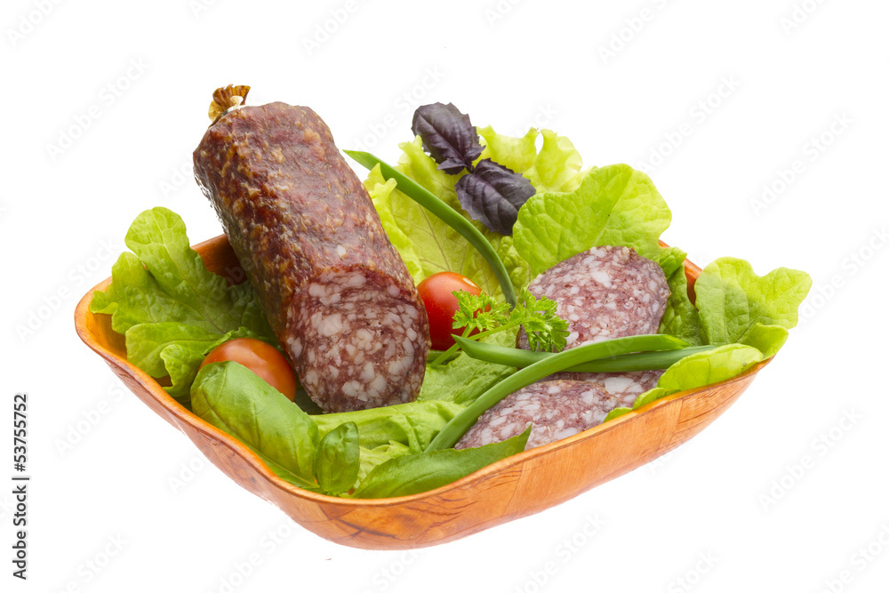 Ripe salami with salad, basil, onion and tomato