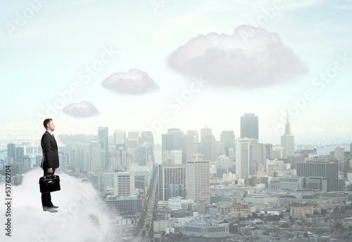 businessman standing on cloud
